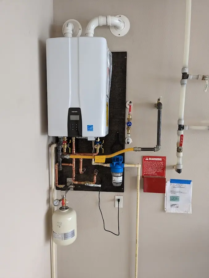 Professional plumber installing copper piping in a Scott home